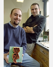 Andrew Greenberg and Mohammed Farhoud pose with their enlarged, 3-D model of a nanoscale structure.