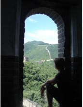 Photo of Meghan Schulz looking out from a watchtower on the Great Wall at Mutianyu.