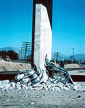 Photo of a steel-reinforced concrete support for a California interstate damaged by an earthquake.
