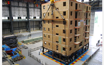 Photo of a six-story condominium building being transported for a full-scale earthquake test.