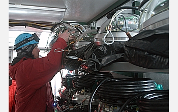 A worker takes a sensor from the shelves at the South Pole drilling site.