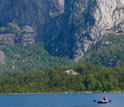 Photo of researchers sampling Norway's Sandvotni Lake.