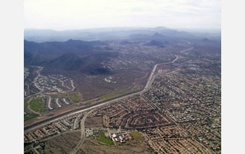 Photo of an aerial view of land, buildings and roads.