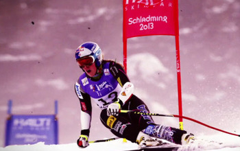Skiier changing direction near a gate