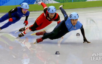 Three speed skaters, one with hand on ice