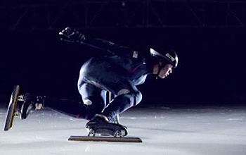 Speed skater leans into a turn on the ice