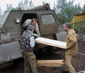 Photo of drill cores being loaded into a truck.