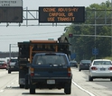 cars on highway and display showing ozone advisory