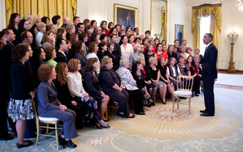 Photo of President Obama greeting teachers in the East Room of the White House.