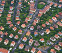 Aerial photo over the Twin Cities show houses and their plant-filled yards.