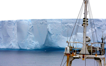 RRS <em>James Clark Ross</em> in front of an iceberg in the Weddell Sea