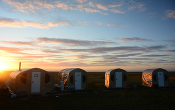 Dawn breaks over the weatherports at the Tutakoke River field camp