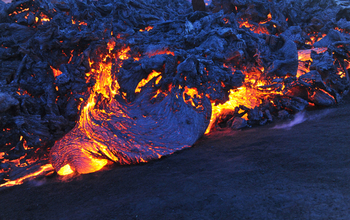 Lobes of basaltic trachyandesite pahoehoe lava slowly advance upslope onto ash covered snow