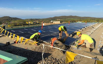 Students install solar panels for a renewable energy program