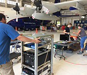Scientists loading measurement instrumentation aboard the NSF C-130 aircraft.