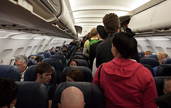 Airplane interior crowded with passengers