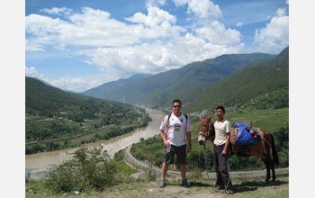 Photo of David Ortega and a man with a donkey at Tiger Leaping Gorge, Yunnan Province, China.