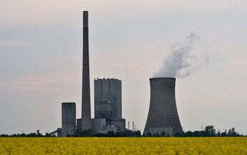 power plant with a filed of flowers in front