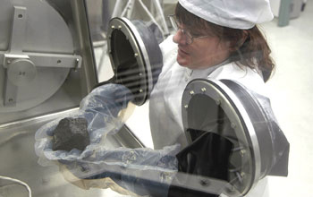 Photo of person processing meteorite.