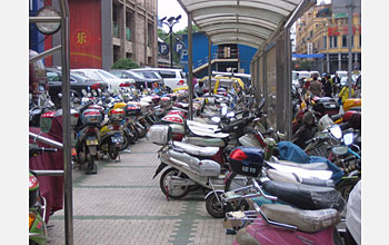 Photo of a parking lot in China filled with electric bikes.