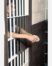 Photo of a prisoner behind bars.