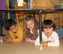 Photo of pre-school students practicing Drop, Cover and Hold On in Santa Barbara, Calif.