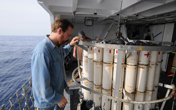 marine chemist Ken Buesseler making a final inspection of a water-sampling rosette.