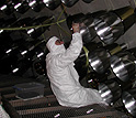 Photo of a technican installing the optical fibers of the experiment's calibration system