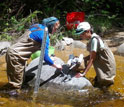 A LoVoTECS coordinator and volunteer scientists mount/calibrate aquatic sensors in New Hampshire.