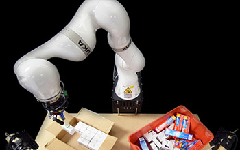 robotic arm packs items into a box