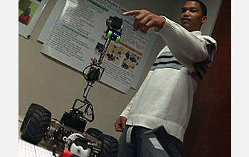 Video still image of Glenn Nickens, a student at Norfolk State University, with his grapling robot.