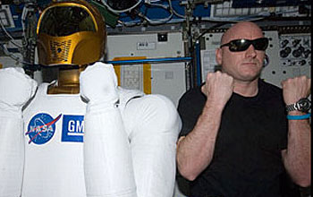 Photo of dexterous humanoid helper Robonaut 2 with Scott Kelly in International Space Station lab.