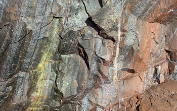 A close-up shows the rocks that make up a wall of the underground mine.