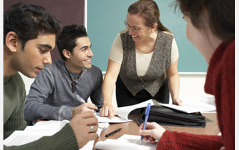 Photo of graduate students working at a classroom table.