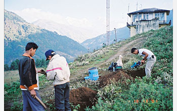 Photo shows Nepali workers and researchers setting up seismic stations.