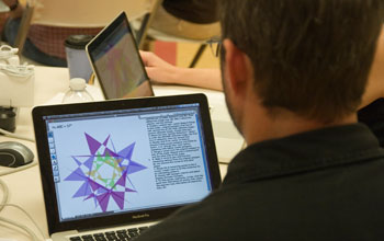 Photo of teacher John Sheridan viewing Geometer's Sketchpad on a laptop.