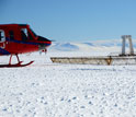 Photo of a helicopter preparing to launch SkyTEM mapping technology on the Antarctic sea ice.