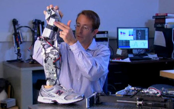 Researcher holding bionic leg model