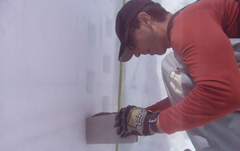Photo of scientist Noah Molotch sampling snow density in a snow pit.