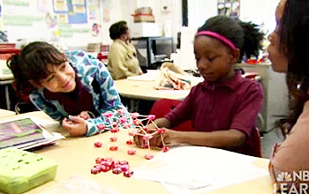 Two students create a model bridge out of candy