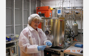 Photo of Diane Hinkens in a "clean room".