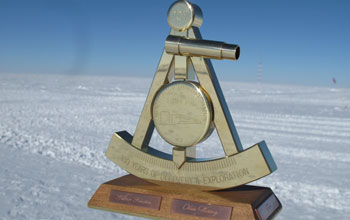Photo of 2011 bronze marker designating the geographic South Pole.