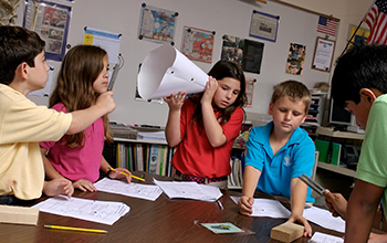 Students test for sound during a science experiment