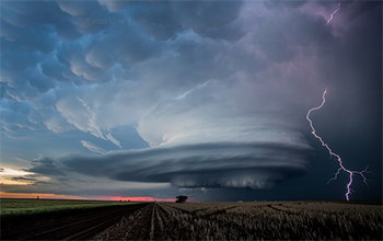 Shelf cloud with lighting over a field