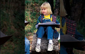 A student takes notes at Gatorville outdoor classroom