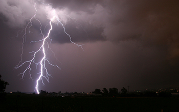 A cloud-to-ground lightning strike during a nighttime thunderstorm in the U.S. Midwest.