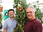 researchers standing with a tomato plant