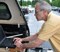 atmospheric scientist Kevin Knupp working on a lap-top connected to a radiosonde system.