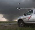 Atmospheric scientists on the TWIRL tornado project set up for an oncoming twister.