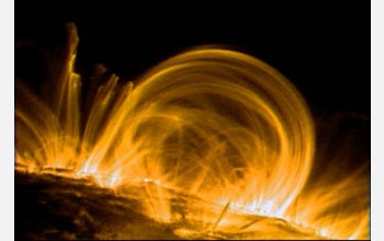 Coils of hot, electrified gas, known as coronal loops, arc above active sunspots.